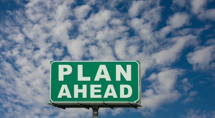 A couple looks over their retirement savings on their laptop. A Fidelity analysis found that a proportional withdrawal strategy from various accounts results in fewer taxes paid throughout a person's retirement.