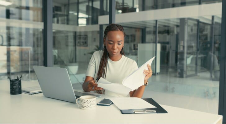 This image shows a woman studying. The CFA is a charter that requires hundreds of hours of study.
