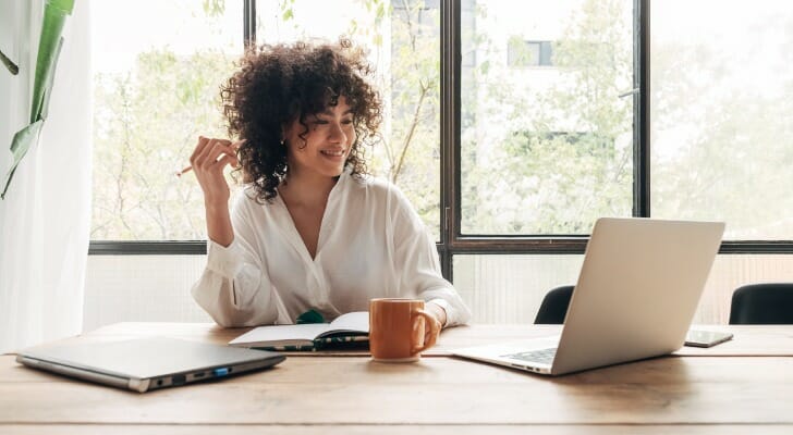 This image shows a woman studying. Earning a CFA requires hours of studying and sitting for three tests.