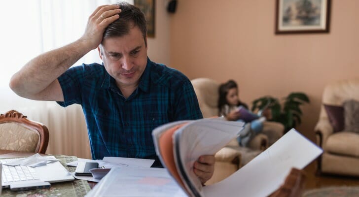 A taxpayer reviewing documents before filing 1099 taxes.