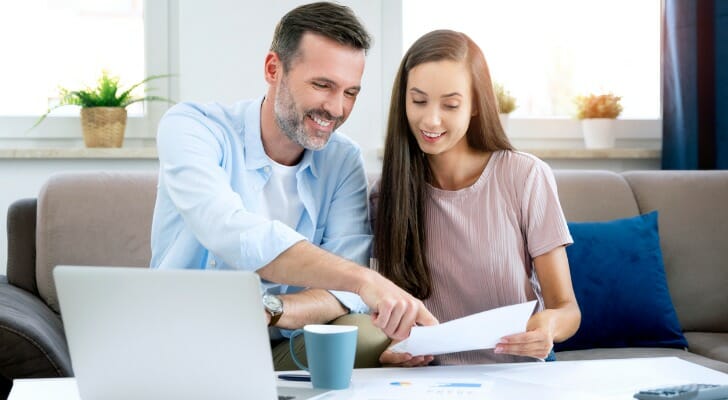 Man discusses his tax-saving strategies with his daughter.