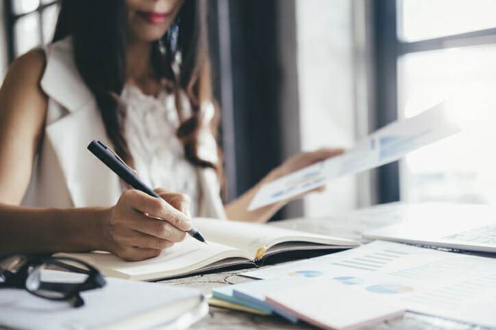 A woman reviews offerings for high-yield checking accounts.