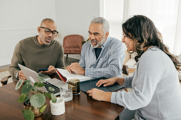 A couple discussing how to avoid taxes on a lump sum pension payout with their advisor.