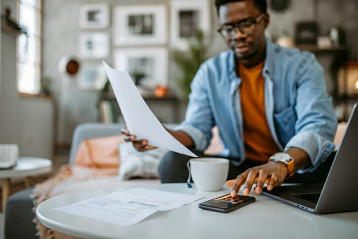 A man researching how much of his savings he should invest.
