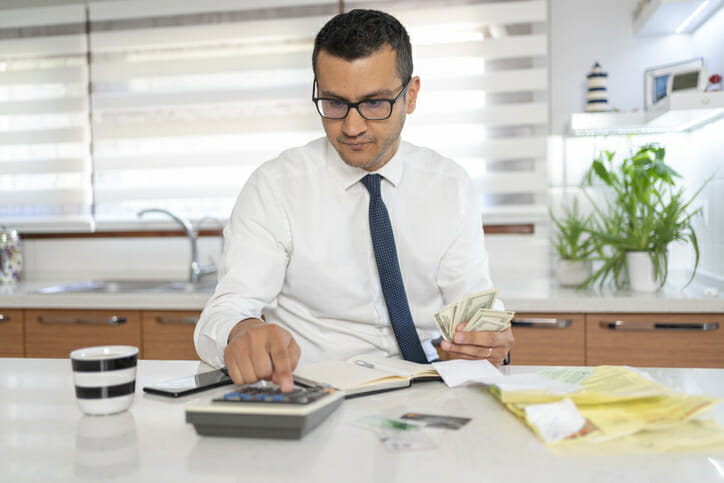 A man calculating interest on his savings.