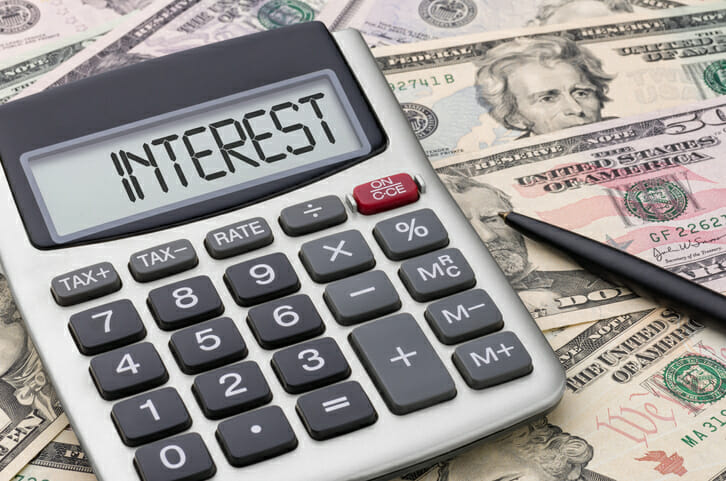 Closeup of a calculator with the word "INTEREST" on the screen.