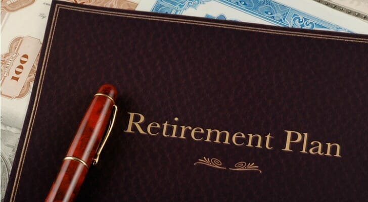 Closeup of a notebook with the words "Retirement Plan" printed on the cover.