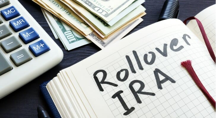 Closeup of an open notebook with "Rollover IRA" written in black marker.