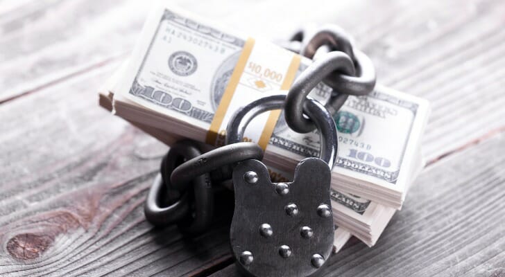 Cash wrapped with a chain and lock to symbolize the lack of liquidity.