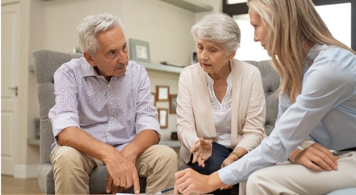A retired couple talks with their financial advisor about an annuity. New research suggests retirees should rethink whether an annuity is actually worth it.