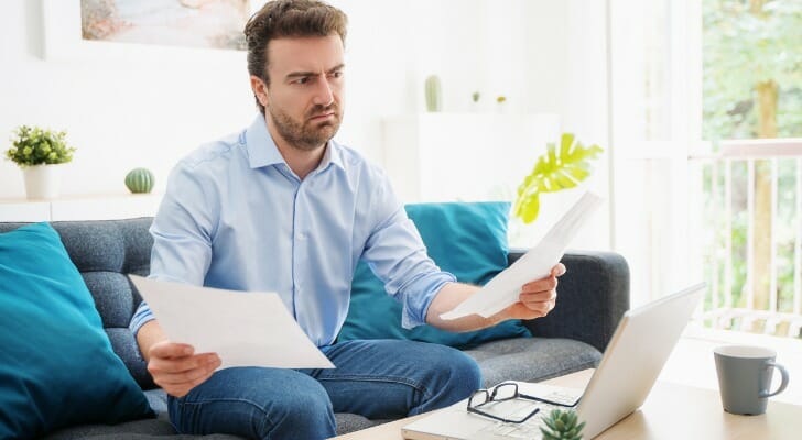 A man compares add-on CDs.