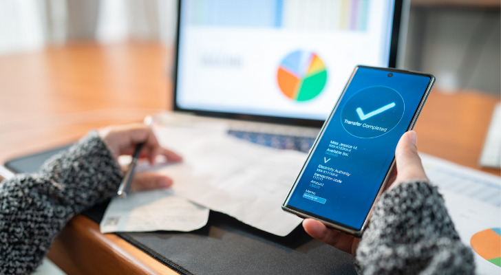 A woman reviews her bank account.