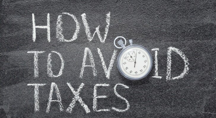 Closeup of a chalk board with "HOW TO AVOID TAXES" written in caps.