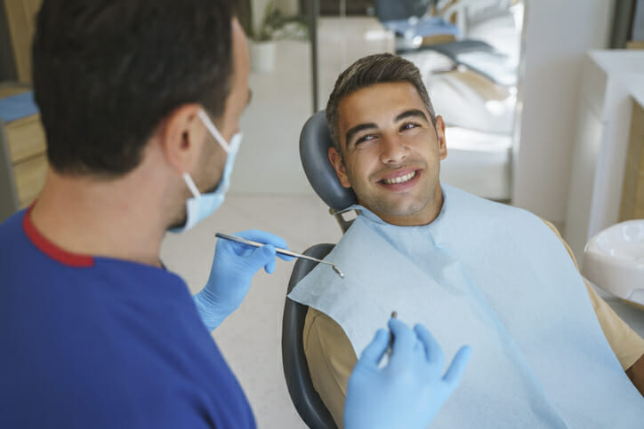 A dentist prepares to check a patient's oral health.