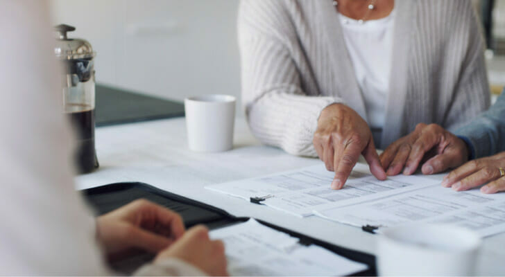 A couple speaking to an advisor about their savings account and Roth IRA.