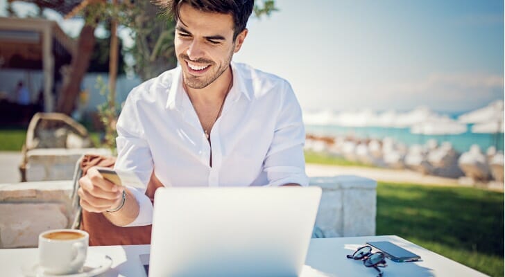 A man traveling in another country away from home, researching "What is an offshore account?"