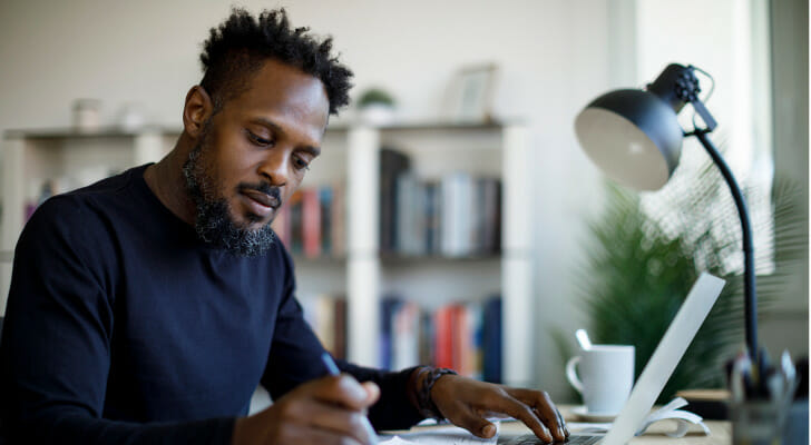 A man calculating how much he needs to keep in savings.