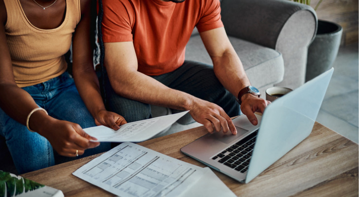 A couple reviewing their bank accounts.