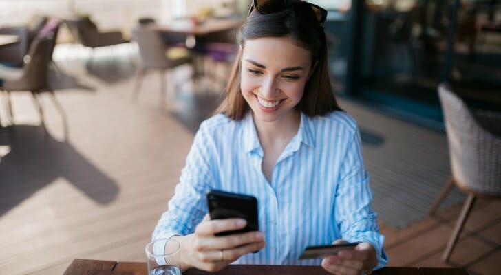 A woman reviewing her savings account on a mobile app.