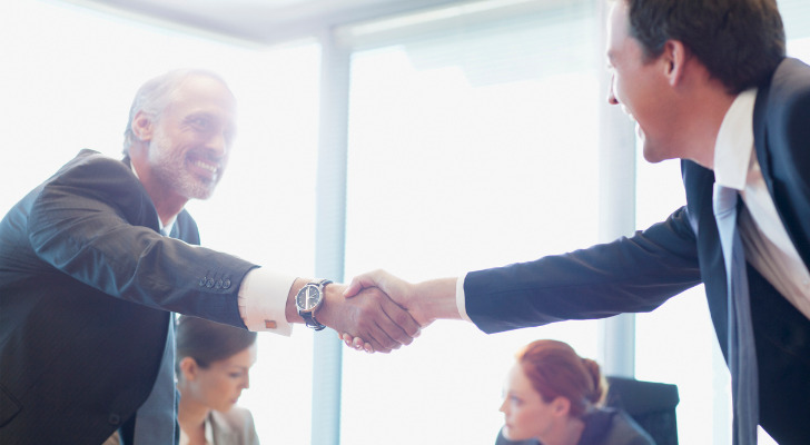 Two business discussing how to avoid capital gains tax on a business sale.