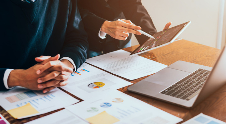 Two financial advisors reviewing a business sale.
