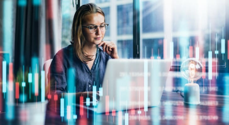 An woman compares target date funds vs. index funds.