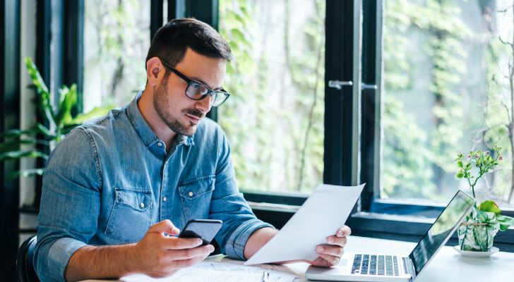 A man reviewing how much he earned in interest from his checking account.
