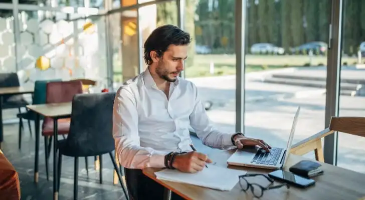A man researching a strategy to minimize capital gains on stocks.
