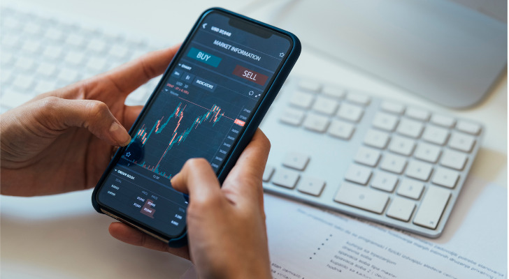 An investor checks their trading account on their mobile app.