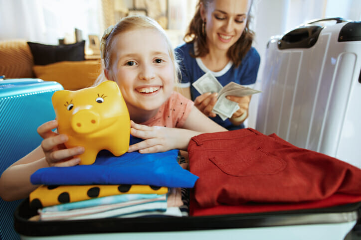 A mother and child counting money for vacation.