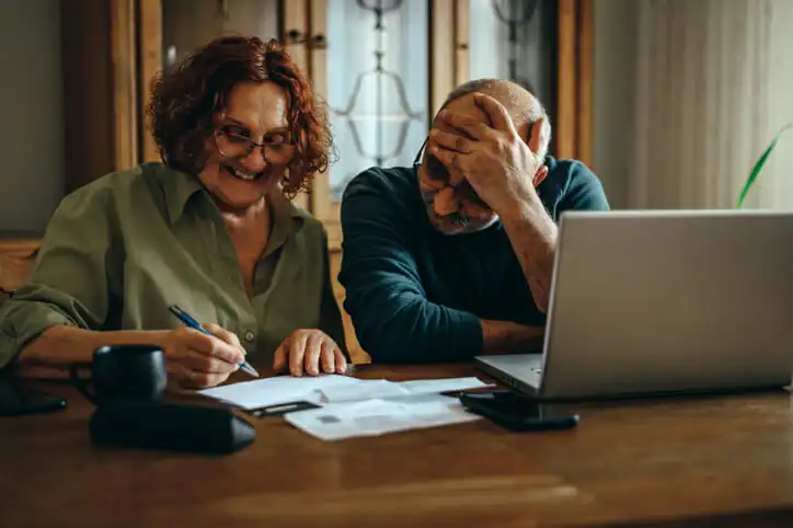 A couple calculating interest for $250,000.