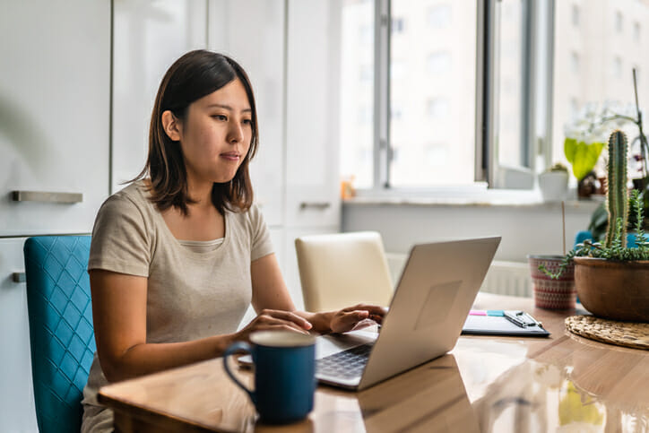 A woman managing her bank account in an effort to avoid overdraft fees.