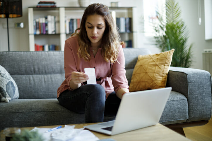 A woman reviewing receipts to file taxes.