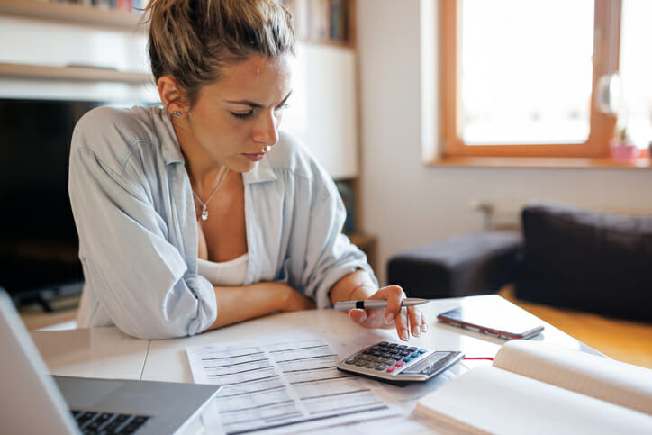 A woman calculating how much interest $2.5 million can earn per year.