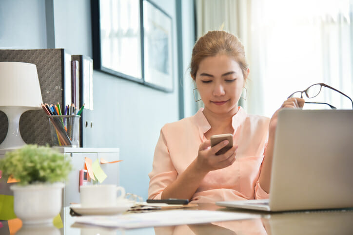 A woman checks her bank account on her mobile app.