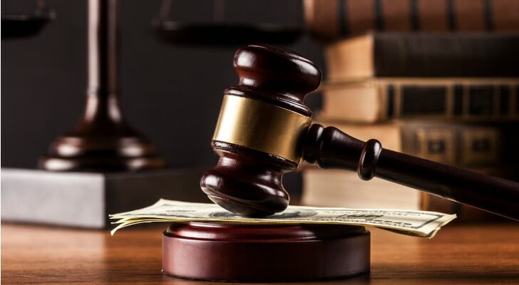 Closeup of a gavel resting on top of cash.