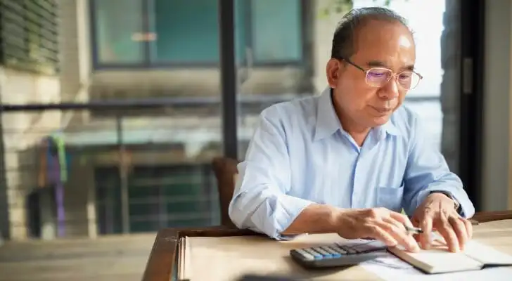 A man calculating how much he could owe in capital gains.