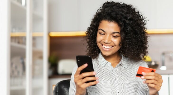 A woman reviewing the balance of her bank account online.
