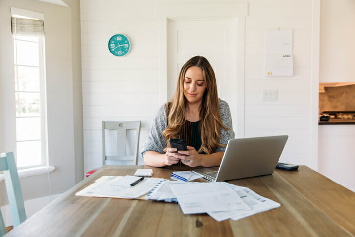 A woman adding up her savings account fees.