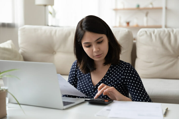 A woman researches how to pick a high-yield savings account.
