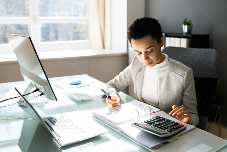 A woman comparing the differences between a share savings account and a bank savings account.