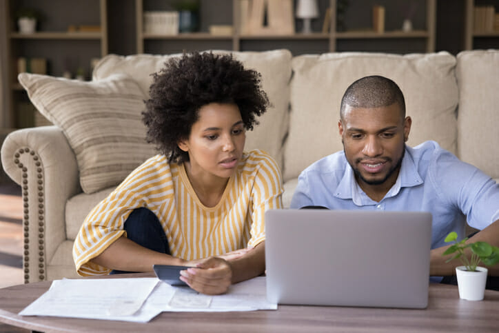 A couple looking up the benefits of a share savings account.