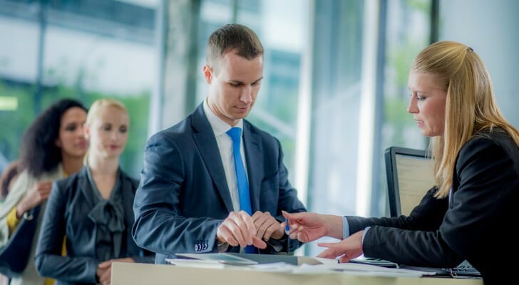 A bank teller assisting a customer.