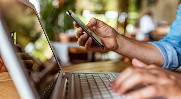 Closeup of a person making a bank transfer online.