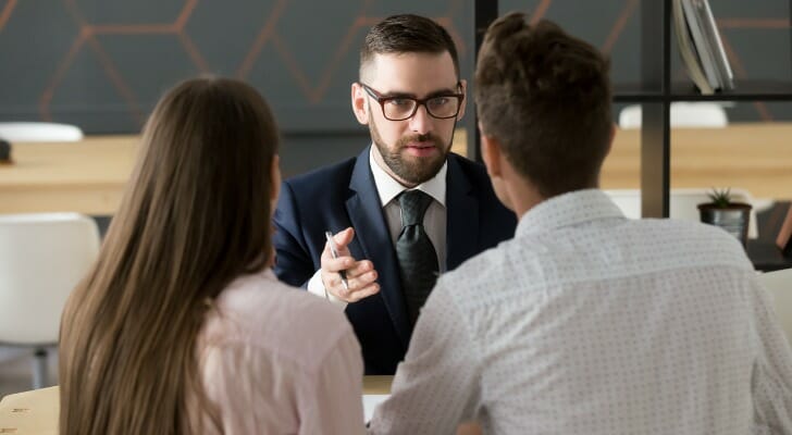 A couple meeting with a financial advisor for lottery winners.