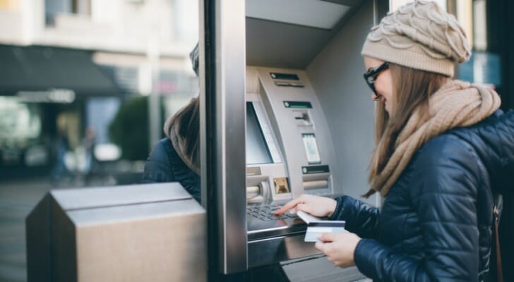 A woman using an ATM.