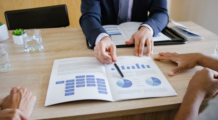 A financial advisor shows a client a potential asset allocation. Research from Dimensional Fund Advisors points to the benefits of diversification.