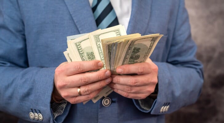 A retiree counting $100 bills.