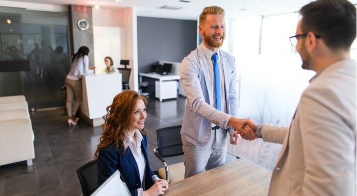 A group of advisors discuss fractional reserve banking.