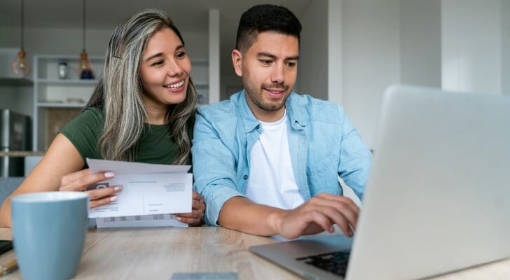 A husband and wife review their checking account.
